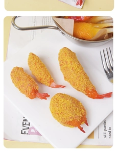 Detailed view of tempura shrimp and crab claw models on a ceramic plate with decor