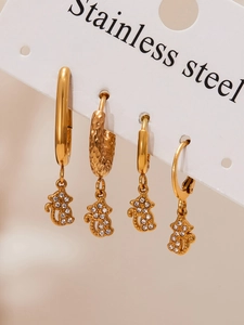 Detailed set of four golden stainless steel hoop earrings with bear-shaped zircon charms