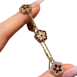 Gold plated flower bracelet with red and white zircon crystals on a multi-flower chain