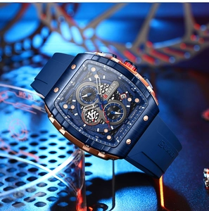 Close-up of blue brushed chronograph watch with rose gold bezel on silicone strap