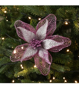 Detail of purple and silver mesh Christmas flower with glitter on a lit Christmas tree
