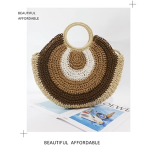 Detail of round straw handbag with circular handle and tri-color woven concentric patterns