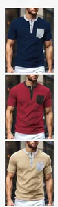Detailed view of color-block waffle knit henley shirts in navy, burgundy, and beige