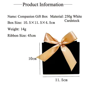 Elegant black gift box with champagne ribbon for festive celebrations and wedding favors