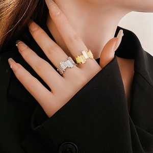 Close-up of geometric gold and silver rings with cubic zirconia on model's hand
