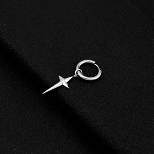 Macro shot of silver stainless steel hoop earring with polished four-pointed star pendant