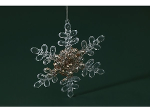 Macro close-up of transparent snowflake ornament with golden glitter and fine hanging cord
