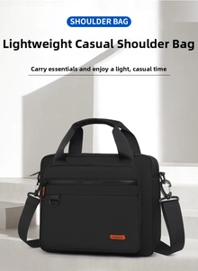 Detail of durable black nylon shoulder bag with orange fashion label and adjustable strap