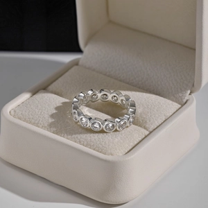 Macro shot of a sparkling silver eternity ring with pavé-set round cubic zirconia gems
