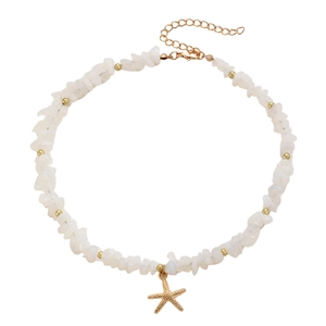 Detailed shot of starfish pendant necklace with white stone beads and gold accents