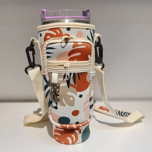 Neoprene 40oz tumbler carrier with tropical leaf print and zippered phone pocket