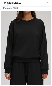 Detail of premium black crewneck sweatshirt featuring drop shoulders and ribbed cuffs