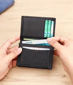 Detailed view of black litchi grain leather card holder with multiple functional slots