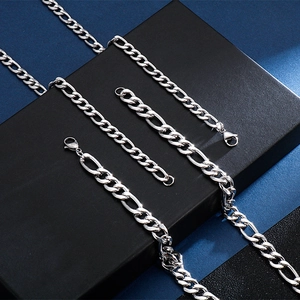 Polished silver stainless steel 3:1 Figaro chain necklaces in multiple lengths on a black box