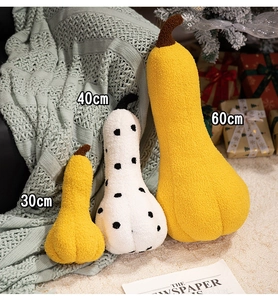 Three sizes of plush pumpkin pillows in yellow and polka dot soft textured fabric
