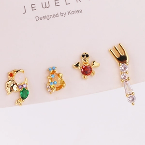 Detail of four gold mermaid-themed studs with colorful zircon on a jewelry card