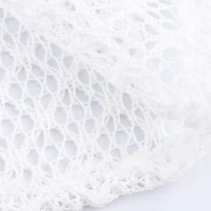 White mesh fabric texture of an off-shoulder dress with refined honeycomb pattern