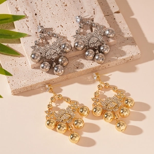 Boucles d'oreilles fleur à pampilles avec zircons en fini or et argent