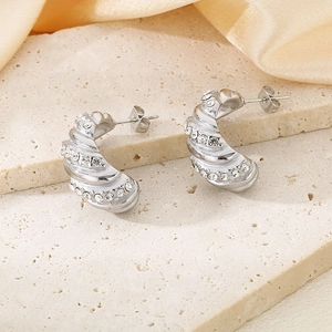 Silver twisted C-shape stainless steel earrings with sparkling rhinestones on stone pedestal