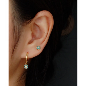 Detailed close-up of S925 silver floral earrings with turquoise stones on ear