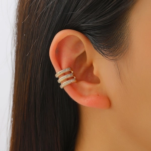 Detailed view of a three-layer gold-plated ear cuff with sparkling zircon inlay