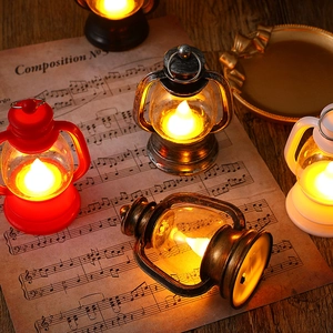 Vintage LED Christmas lanterns in various colors on a rustic wooden table with warm lighting