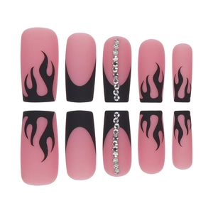 Long coffin matte press-on nails featuring black flame patterns and rhinestone accents