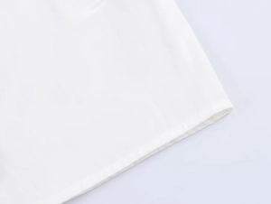 Detailed close-up showing the professional hem stitching on white poplin shirt fabric