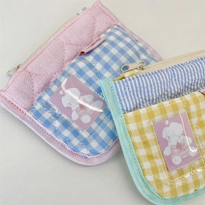 Macro shot of cute cotton coin purses with quilted patterns and clear ID window slots