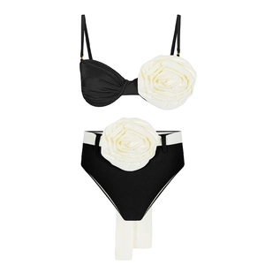 Detail of high-waisted bikini with black and white color block and 3D floral accents