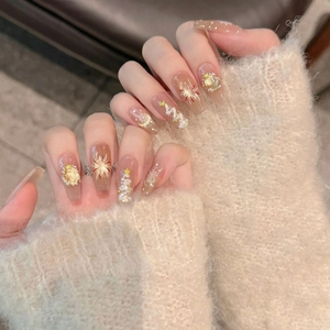 Macro detail of Christmas press-on nails featuring hand-painted snowflakes and 3D pearls