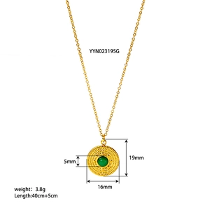 Macro view of gold vintage necklace with turquoise pendant and embossed textures