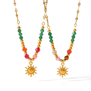 Detail of colorful stone beads and gold sun pendant on stainless steel necklace