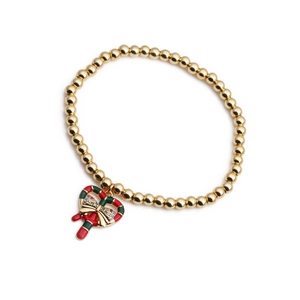Détail du bracelet élastique doré avec pendentif canne à sucre en zircon et nœud