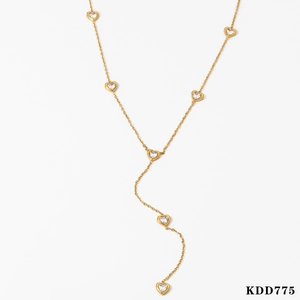 Detailed view of Y-shaped gold necklace featuring tiny cubic zirconia heart pendants