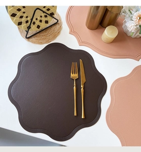 Detail showing the floral edge and textured faux leather of deep brown placemats