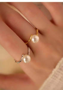 Detailed close-up of S925 silver bamboo-style rings with pearls on model finger