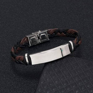 Detail of woven black and brown leather bracelet with polished stainless steel plate