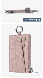 Macro view of pink lychee grain leather wallet thickness compared with a coin
