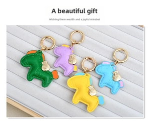 Detail view of handmade leather pony keychains in four colors with gold lucky bag charms