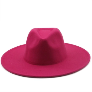 Top view of a magenta wide brim wool felt jazz fedora hat on a white background