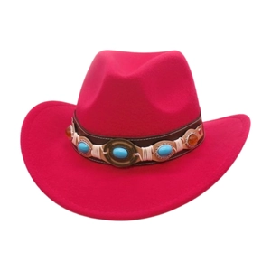 Close-up of rose red felt cowboy hat with vintage leather band and turquoise ethnic gems