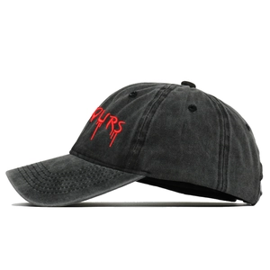 Side view of washed black baseball cap featuring red liquid-style PURS embroidery