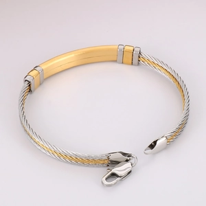 Detailed macro view of two-tone braided steel wire bracelet with polished metal plate