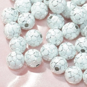 Macro shot of white acrylic soccer beads with silver lines for DIY jewelry making crafts