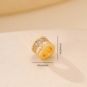 Macro view of gold-plated bead showing 0.7cm diameter and zircon stone details