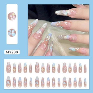 Floral stiletto press-on nails with blue-pink gradient and glitter stars design