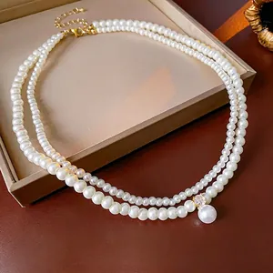 French style double-layer pearl necklace with a large pendant and gold zircon accents