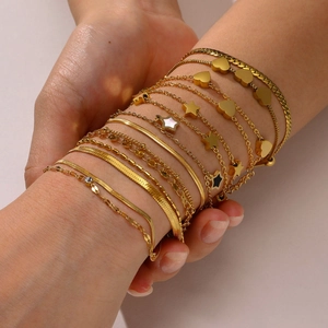 Layered gold stainless steel bracelet set with zircon charms and flat snake chain styles