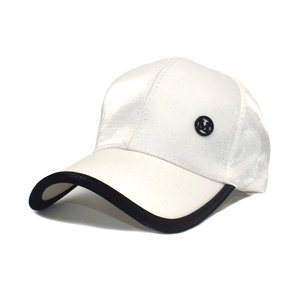 Detail of white satin baseball cap with black contrast brim and metal M logo badge